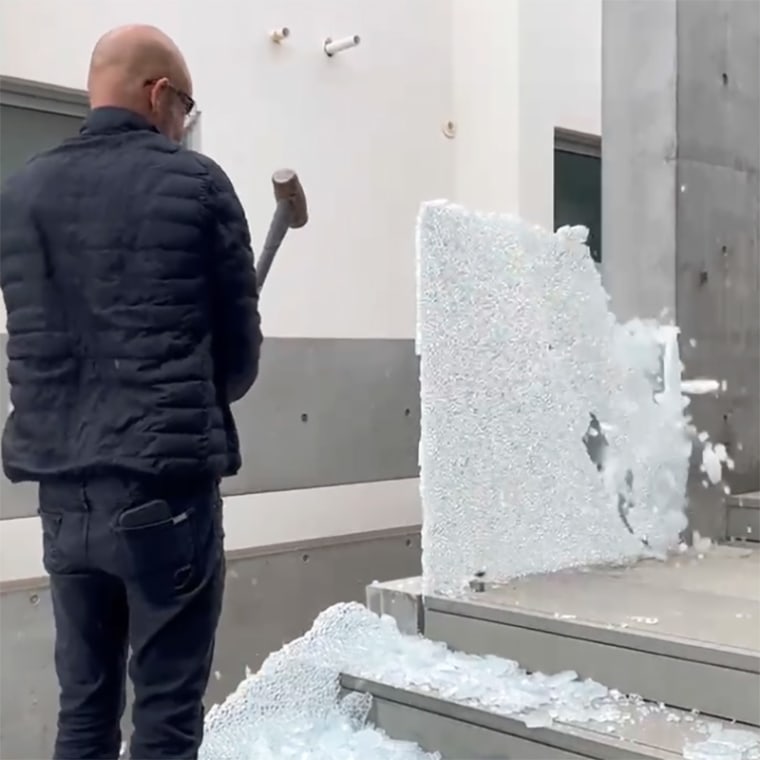 A worker demolishes glass at Ye’s Malibu home.