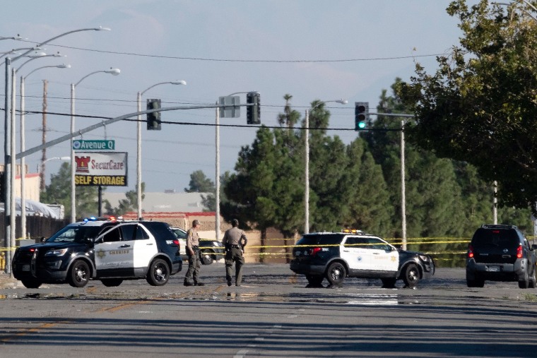 Police cars block off a street where a sheriff's deputy was shot while in his patrol car in Palmdale, Calif. on Sept. 17, 2023.
