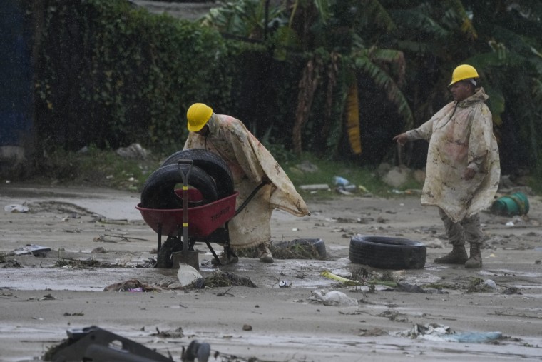Mexican soldiers remove tires from the mud Saturday after Hurricane Norma hit a beach in San Jose del Cabo, Mexico.