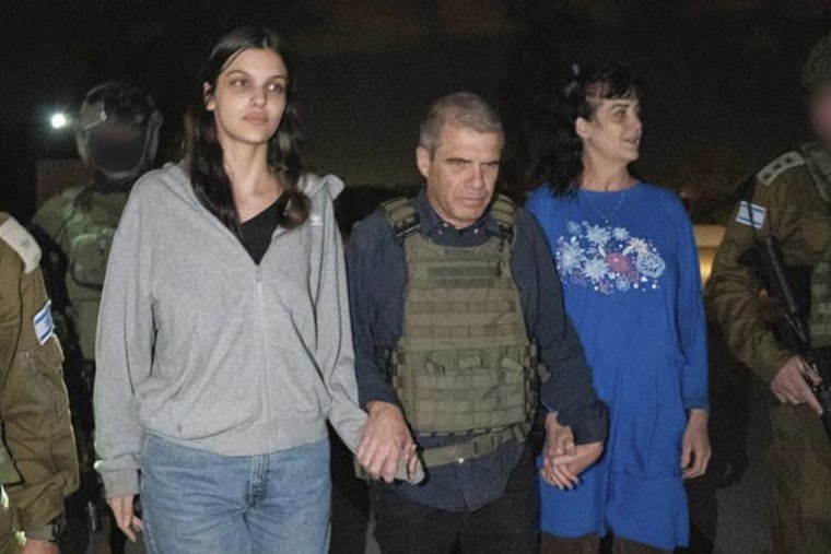 Judith Raanan, right, and her 17-year-old daughter Natalie are escorted by Gal Hirsch, Prime Minister Benjamin Netanyahu's special coordinator for returning the hostages, as they return to Israel from captivity in the Gaza Strip on Oct. 20, 2023. 