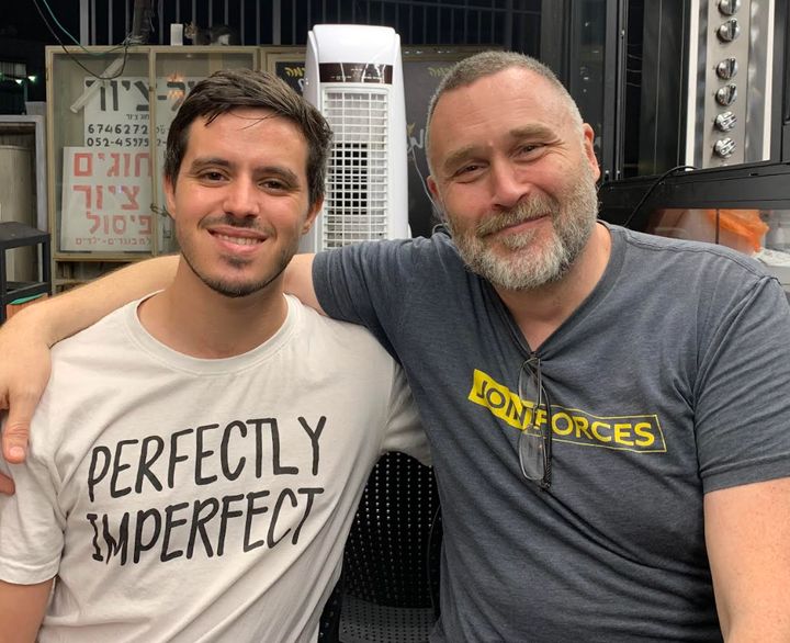 The author (right) with his boyfriend Avichai in Israel in October 2023. "This photo is from the only night we went outside to eat," he writes.