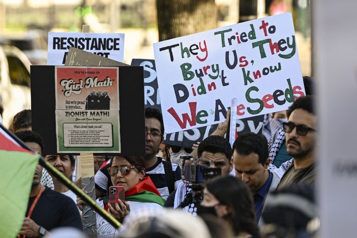 People hold Palestinian flags and banners in Washington, D.C. 