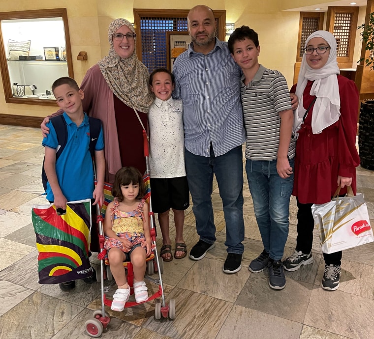 Emilee Rauschenberger, left, with her husband, Mohammad Abuhamad, and five children.