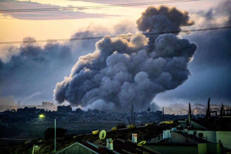 Smoke rises above buildings during Israeli strikes in northern Gaza on Nov. 22, 2023, as seen from the Israeli side of the border.