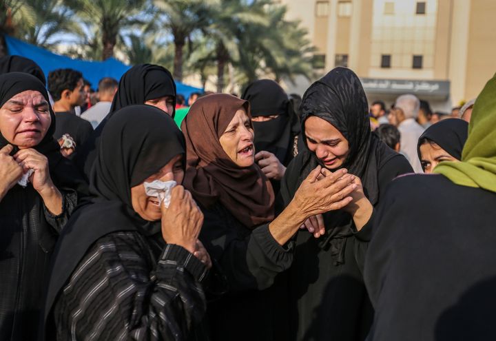 People mourn as they collect the bodies of Palestinians killed in Israeli air raids on Nov. 3 in Khan Yunis, Gaza. The Gaza strip, a besieged Palestinian territory, is under heavy bombing from Israel in response to the Oct. 7 attacks by Hamas. Pressure is mounting from the international community for a humanitarian truce.
