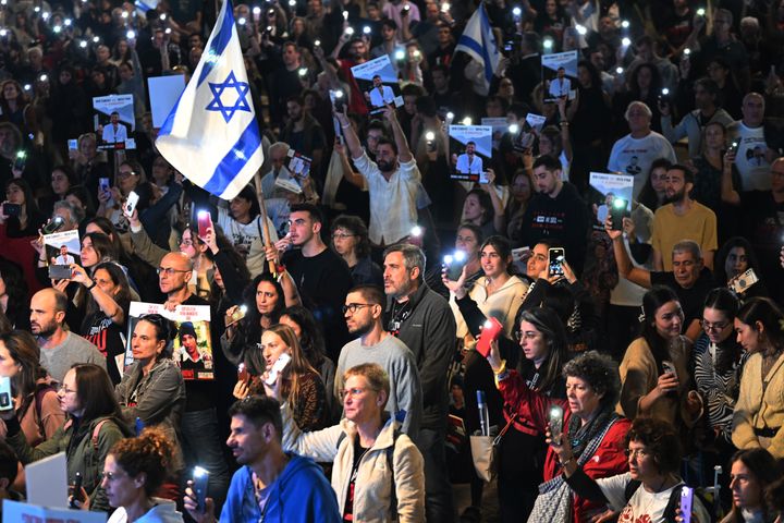TEL AVIV, ISRAEL - NOVEMBER 25: Thousands of people and the families of hostages hold up their mobile phones with the torch on to sing the national anthem during the ‘50 Days of Hell’ rally in support of the 212 hostages that are still being held by Hamas, as another 13 Israeli hostages are supposed to be released from Gaza and brought back to Israel, during the second day of the temporary truce, outside The Museum of Modern Art known as the 'The Hostages and Missing Square' on November 25, 2023 in Tel Aviv, Israel. According to event organizers 50,000 people were expected to attend with organized buses from around the country, as well as flights with the displaced families staying in Eilat of hostages from the communities around the Gaza Envelope.A total of 50 hostages currently held by Hamas are to be released during a four-day truce with Israel, the first such pause in fighting since Oct. 7, when Hamas launched its surprise attack and Israeli responded with a vast military offensive to destroy the militant group that governs Gaza. Under the deal, 150 Palestinian prisoners are also to be released from Israel, and more humanitarian aid will be admitted at the Gaza-Egypt border crossing. (Photo by Alexi J. Rosenfeld/Getty Images)