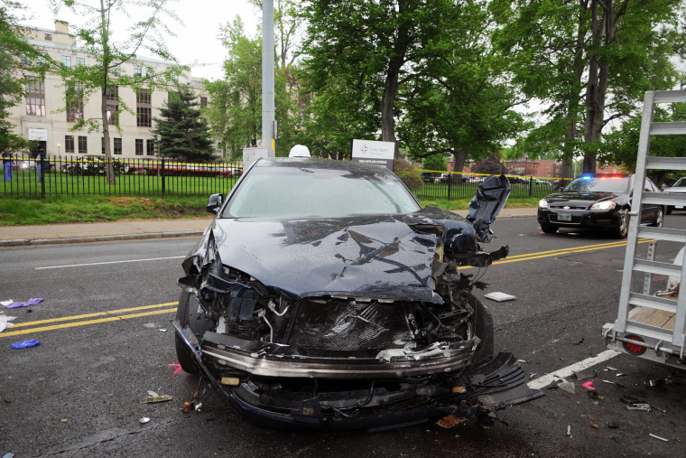 An officer fired into a suspect's car after a DEA task force boxed in the vehicle in Hartford, Conn., in 2018, injuring the suspect. The vehicle was smashed.