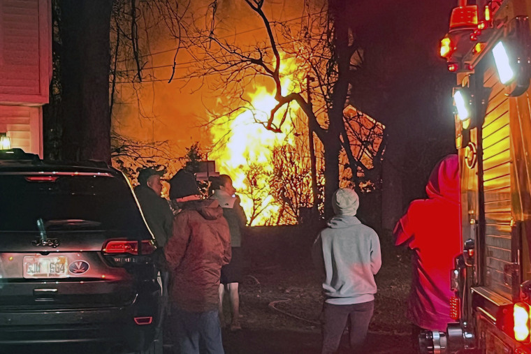 Officials are investigating the circumstances surrounding a massive explosion that destroyed a duplex and shook a Virginia suburb of Washington, D.C. (AP Photo/Emily Saxon)