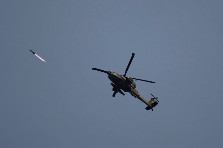 Israeli attack helicopter shoots a missile over the Gaza Strip on Saturday, Dec. 9, 2023. (AP Photo/Leo Correa)