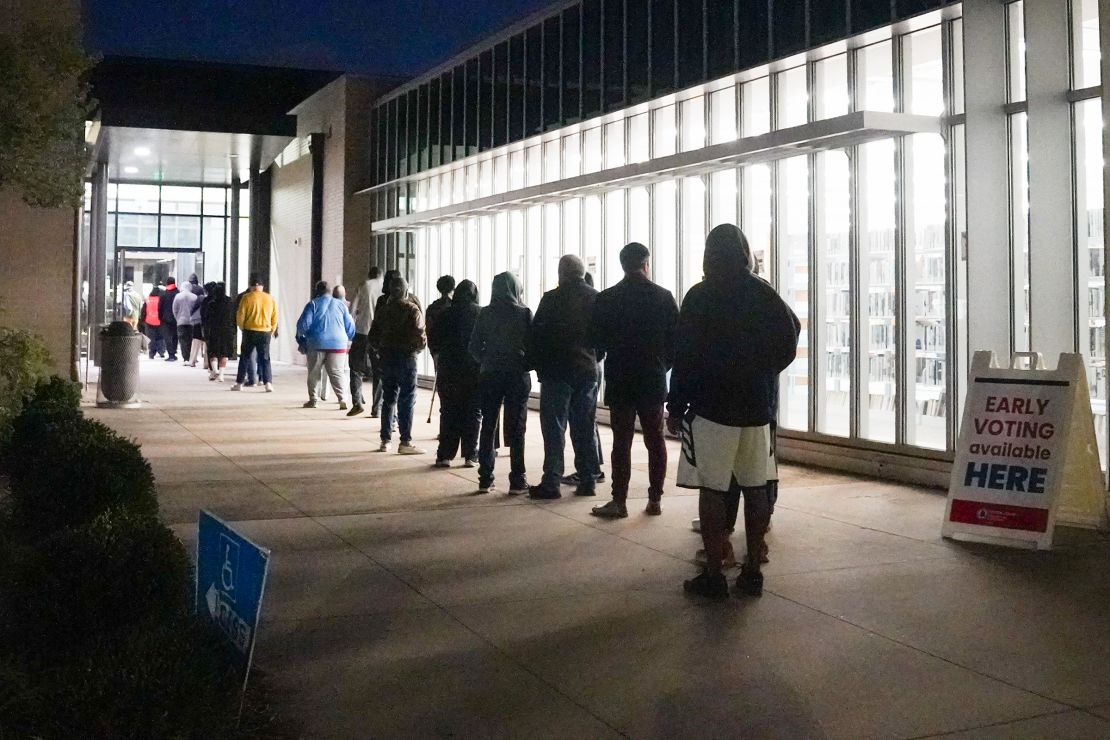 People stand in line at Metropolitan Library to cast their votes in the US presidential election on October 15 in Atlanta.