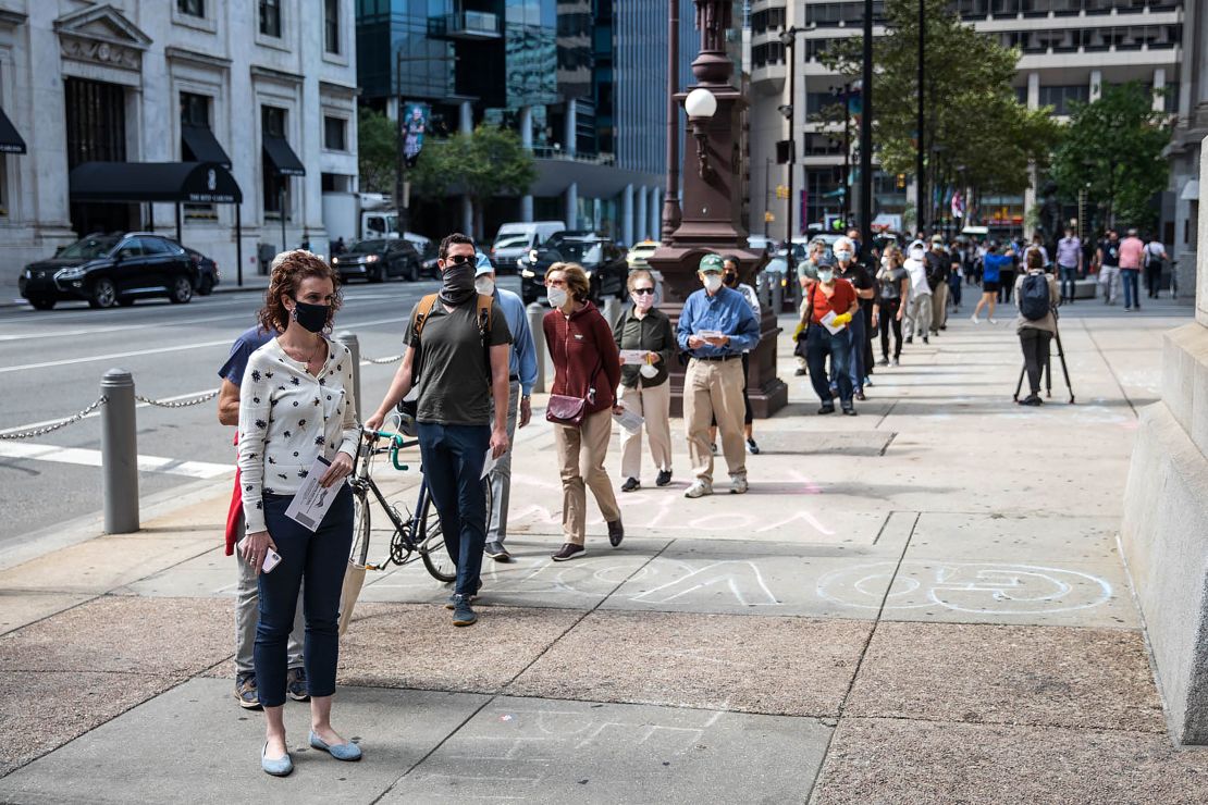 People wait in line to cast their vote during early voting at City Hall in Philadelphia, Pennsylvania on October 7, 2020