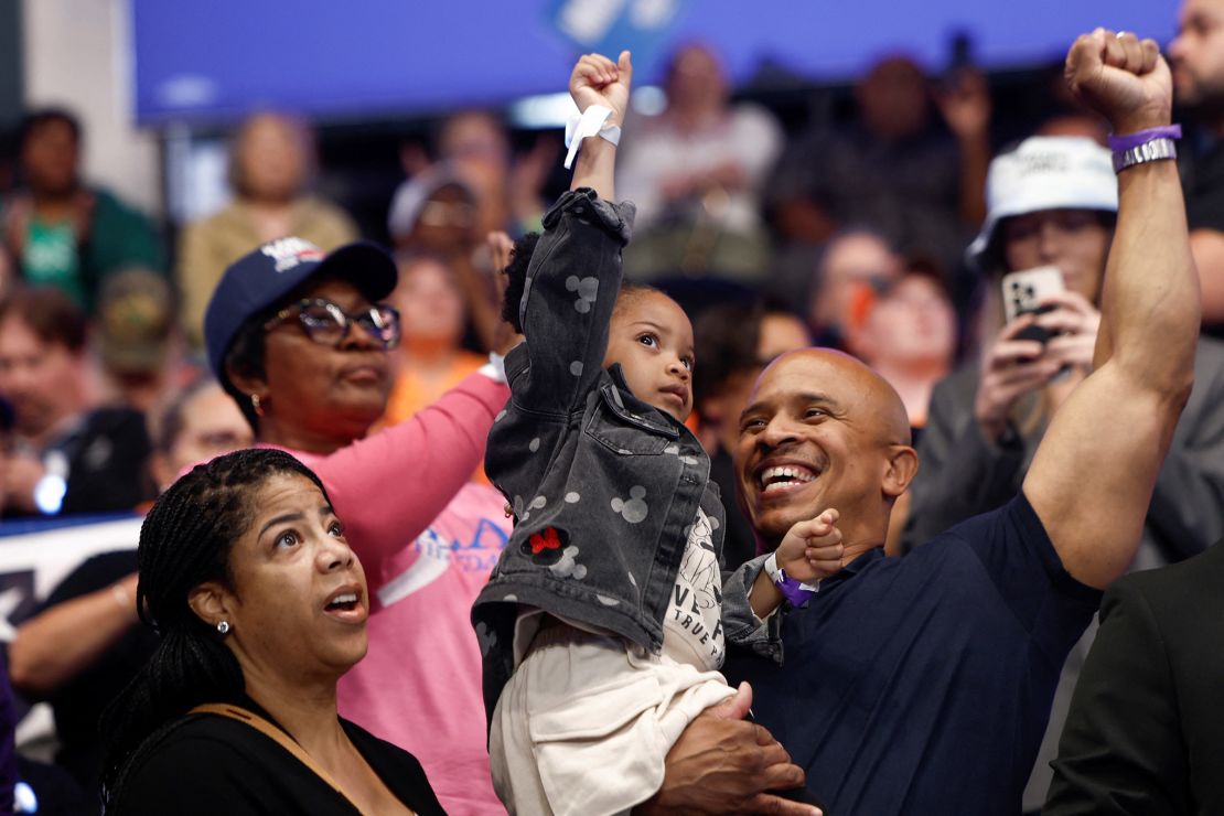 A child gestures during a campaign event for Vice President Kamala Harris at the Dort Financial Center in Flint, Michigan, on October 4, 2024.