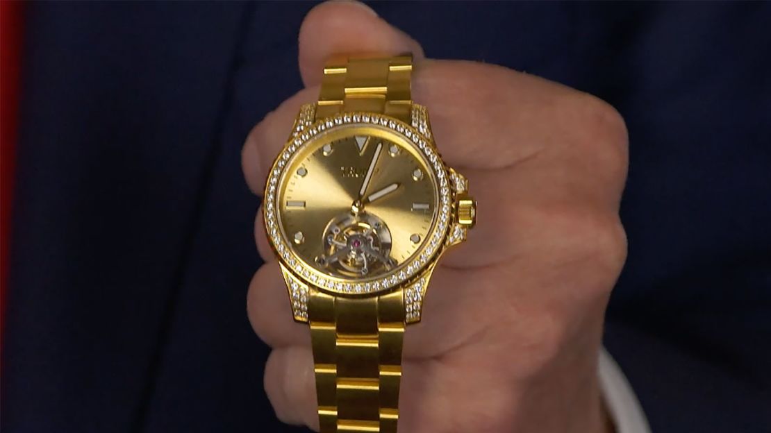 In this still from video, former President Donald Trump holds a Trump watch.